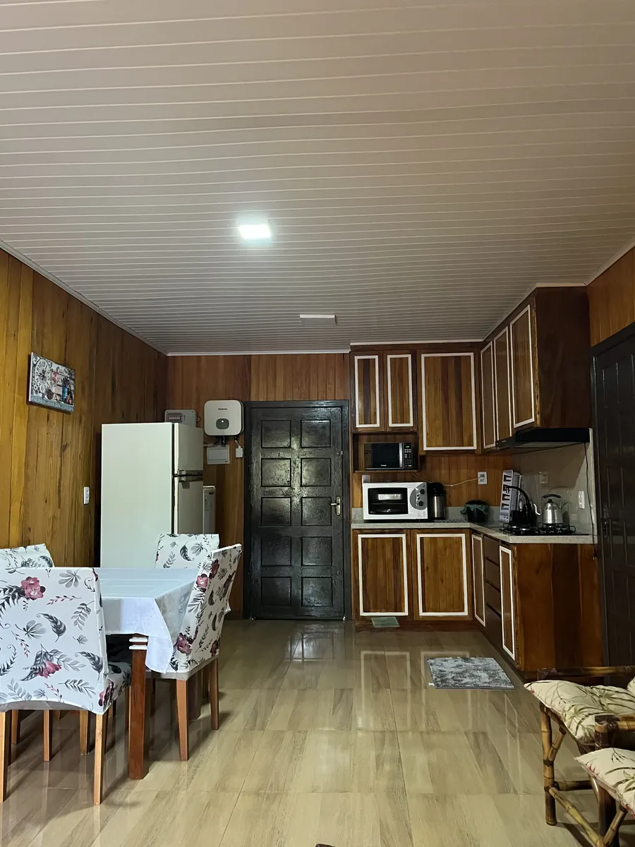Cozinha equipada e mesa de refeições da Cabana Aconchego